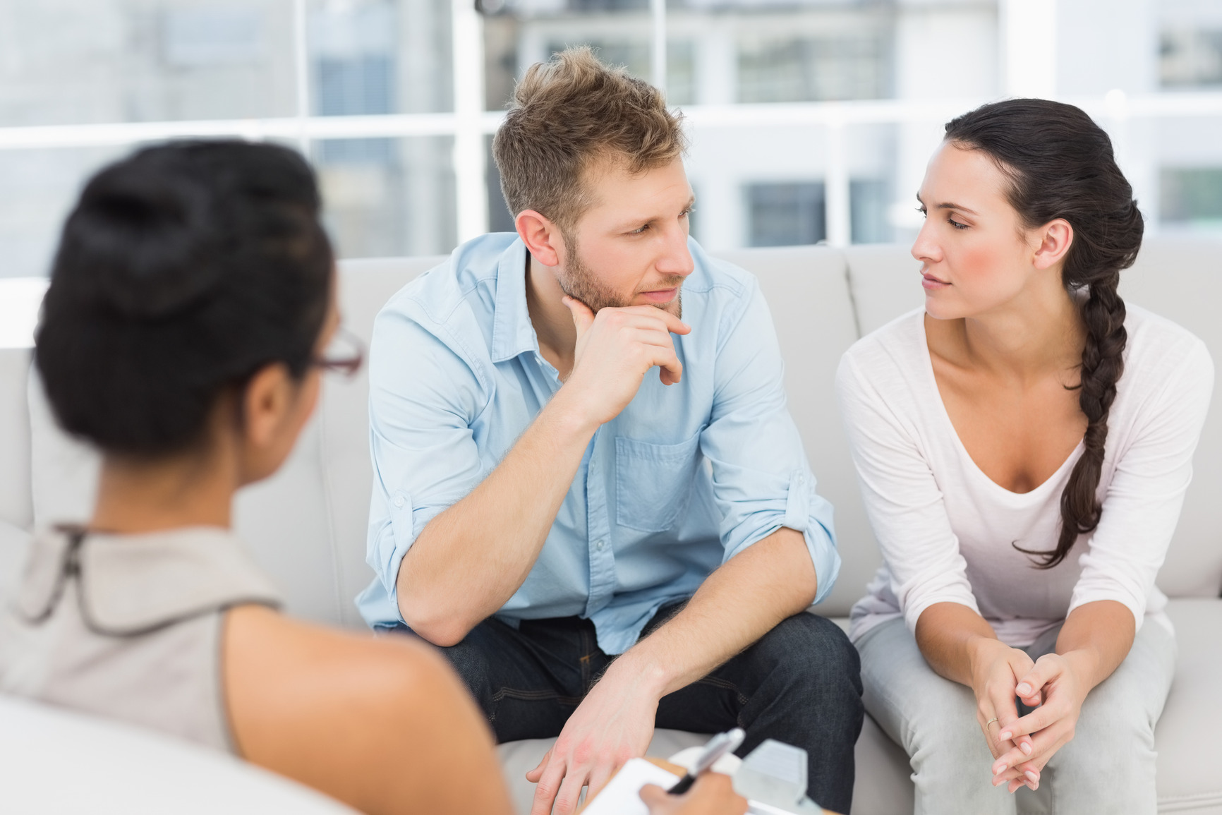 Unhappy couple at therapy session in therapists office